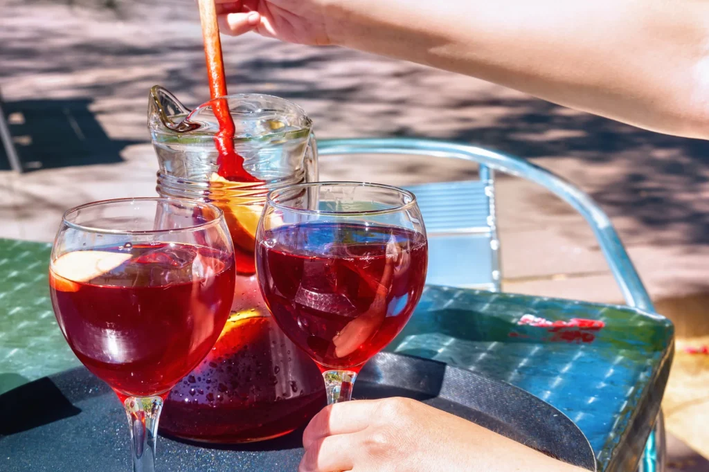 Jug and glasses with sangria beverage on the table in street cafe in center of Barcelona. Spain.
